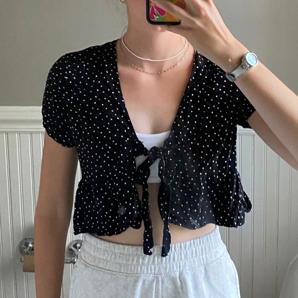 Black polka dotted tie front top